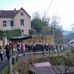 Marcheurs sur une route en montée, une maison qui surplombe